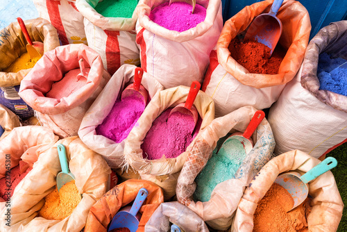 Bright moroccan dry paint in open sacks, dyes powdered pigments, paint of different typical colors for sale. Blue town Chefchaouen, Morocco © dsaprin