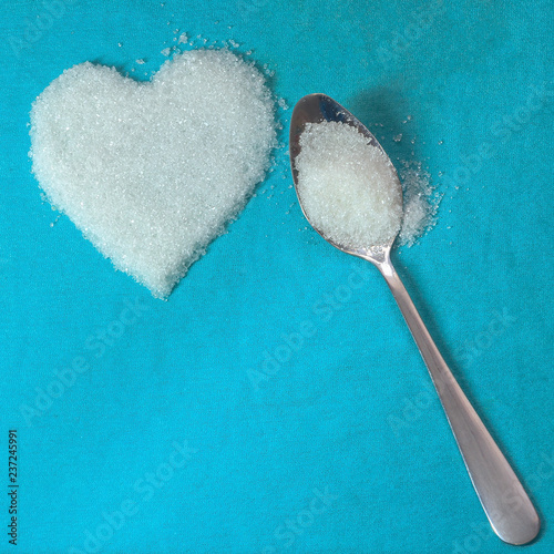 Принти на полотні Square frame with a spoon of sugar and a snow-white heart of sugar on a blue fab