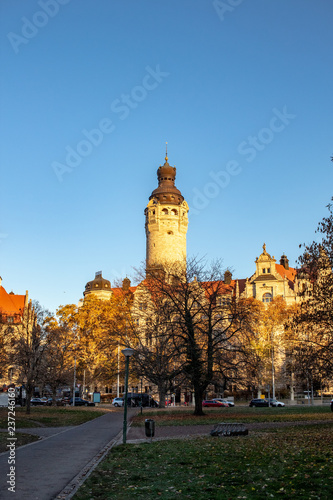 Wonderful autumn panorama with park landscape, city skyscraper, new city hall and brightly colored trees and leaves in Leipzig