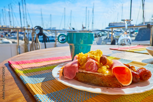 Meet the morning in Valletta marina with a mug of aroma coffee and fresh satisfying sandwich with omelette, bacon and cheese, Malta. photo