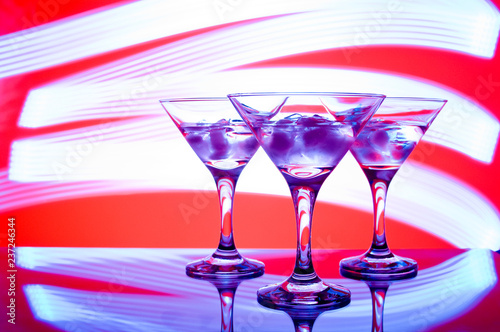 alcoholic glass in the club entourage, copy space, red background