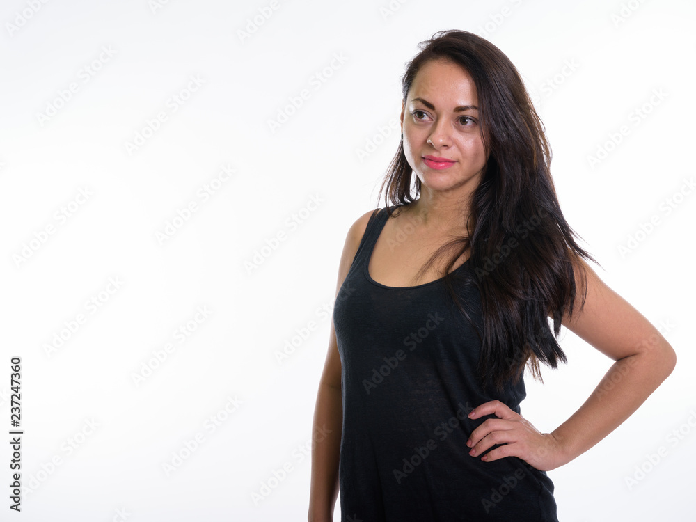 Studio shot of beautiful woman thinking while posing against whi Studio shot of beautiful woman thinking while posing against whi