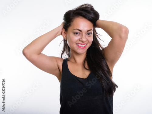 Close up of happy beautiful woman smiling while holding hair aga