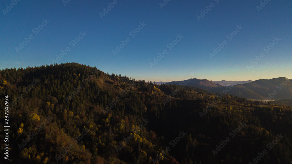 Majestic sunrise in the mountains landscape. Carpathian mountins with blue sky panoramic wiew, Ukraine.