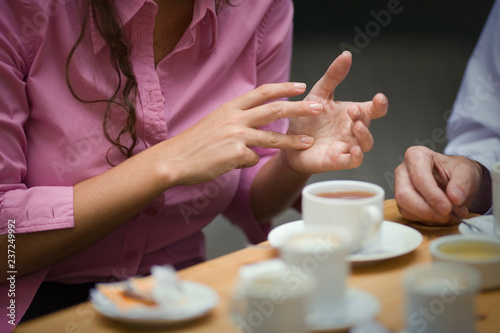 Cropped view of a woman gesturing with her fingers. photo