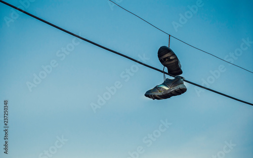Shoes hanging on cables as spot sign of drug dealing