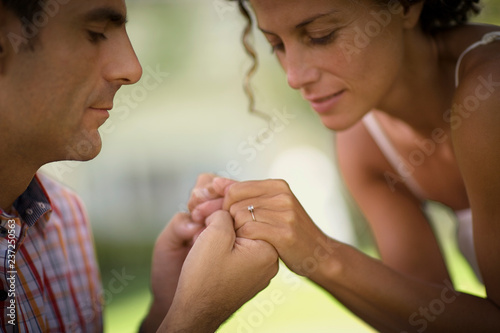 Side view of a couple holding hands.