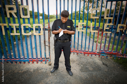 View of a security guard near a gate.