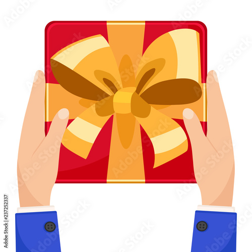 Gift box with bow in hand on a white. The view from the top.