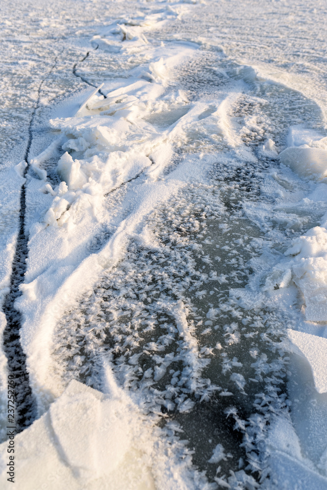 View from above on frozen lake texture. Frost created a beautiful decoration from crushed ice pieces and snow. Winter vertical background. View from above on frozen lake texture. Frost created a beautiful decoration from crushed ice pieces and snow. Winter vertical background.