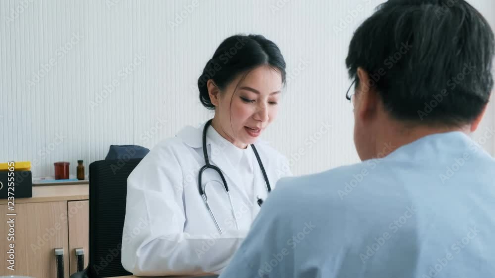 Doctor with patient. Young female medical doctor talking to a senior patient at hospital. Looking at computer to discuss medical examination result. Senior care medical and insurance concept. Doctor with patient. Young female medical doctor talking to a senior patient at hospital. Looking at computer to discuss medical examination result. Senior care medical and insurance concept.