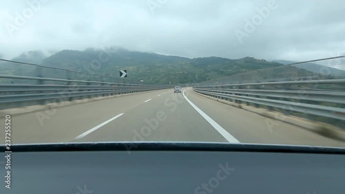 Driving over long curving bridge in Sicily, Italy. Autoroute E90 between Messina and Palermo, Sicily, Italy. photo