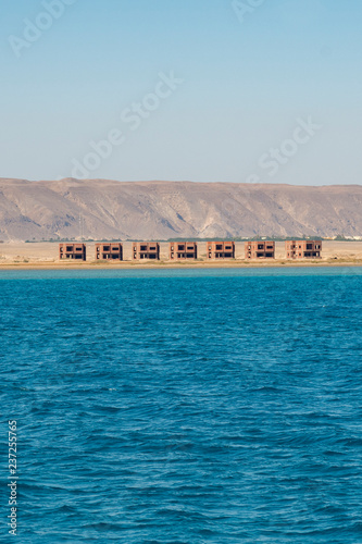 Unfinished houses by the sea. Unfinished buildings of new hotel resort in Egypt. Horizontal color photography. vertical photo