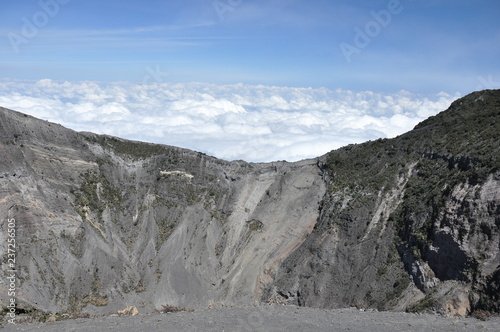 Irazu volcano in Costa Rica. Crater in clouds with protective barriers. Fragments of lava and pumice.