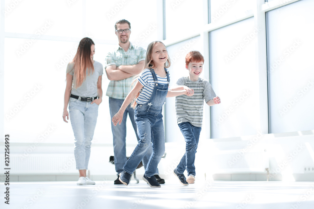 Fototapeta premium happy family standing in new spacious apartment