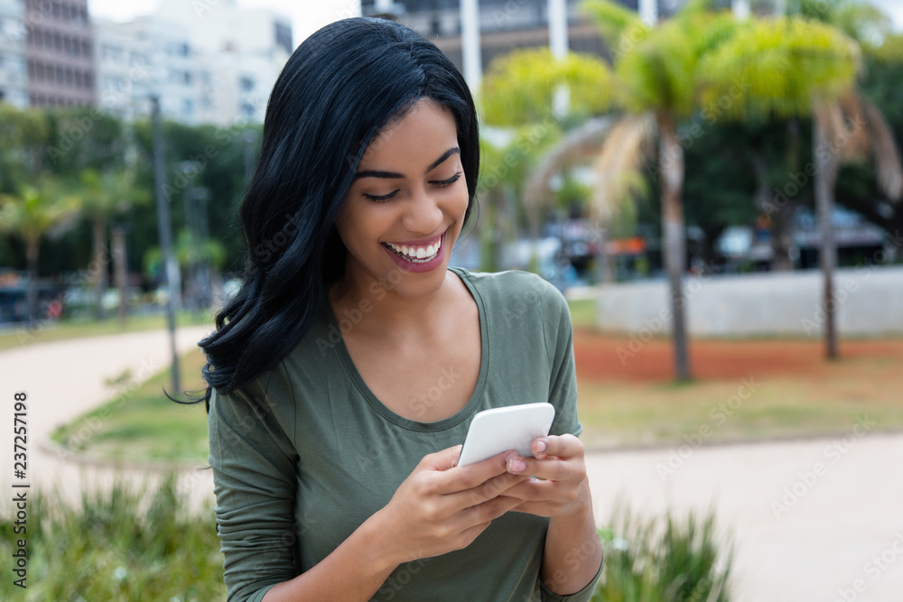 Beautiful indian woman sending message with phone Beautiful indian woman sending message with phone