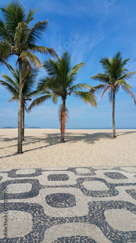 Ipanema Beach Rio de Janeiro boardwalk with palm trees and blue sky