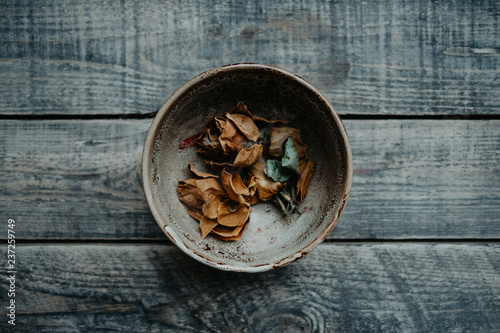 rustic bowl full of autumn dry leaves photo