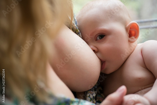 Mother breast feeding baby photo