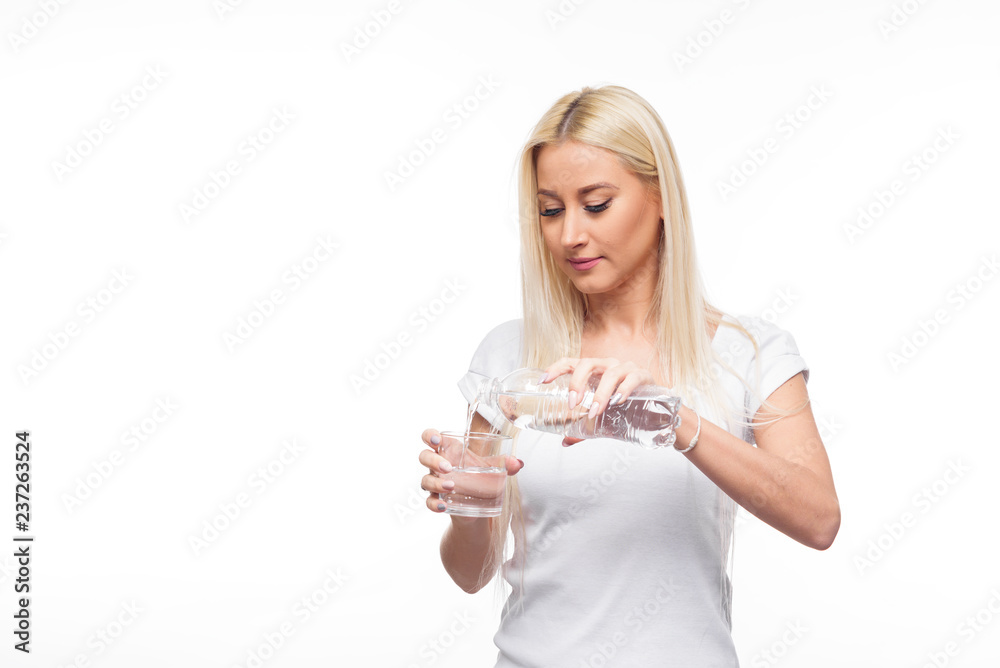 Healthy blond woman holding a pure bottle and drink glass of water on isolated white background Healthy blond woman holding a pure bottle and drink glass of water on isolated white background