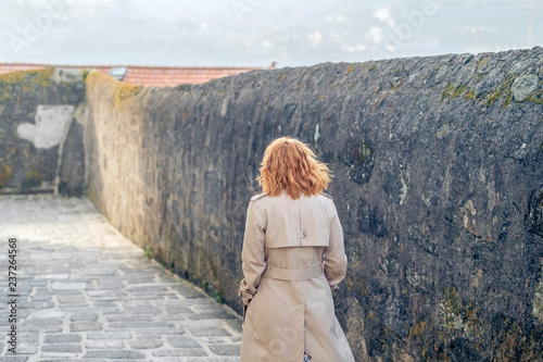 young woman near the wall