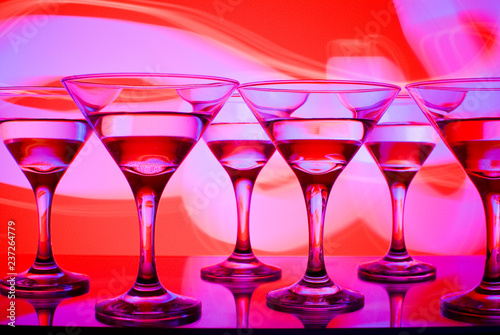 alcoholic glass in the club entourage, copy space, red background