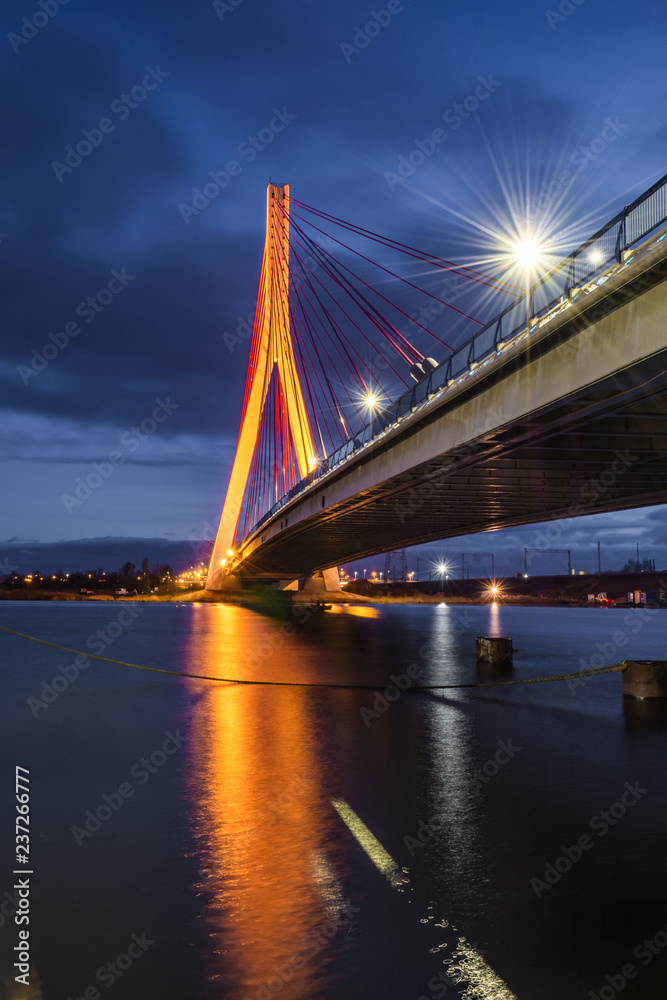 Fototapeta premium Illuminated cable stayed bridge over Martwa Wisla river at night in Gdansk. Poland Europe