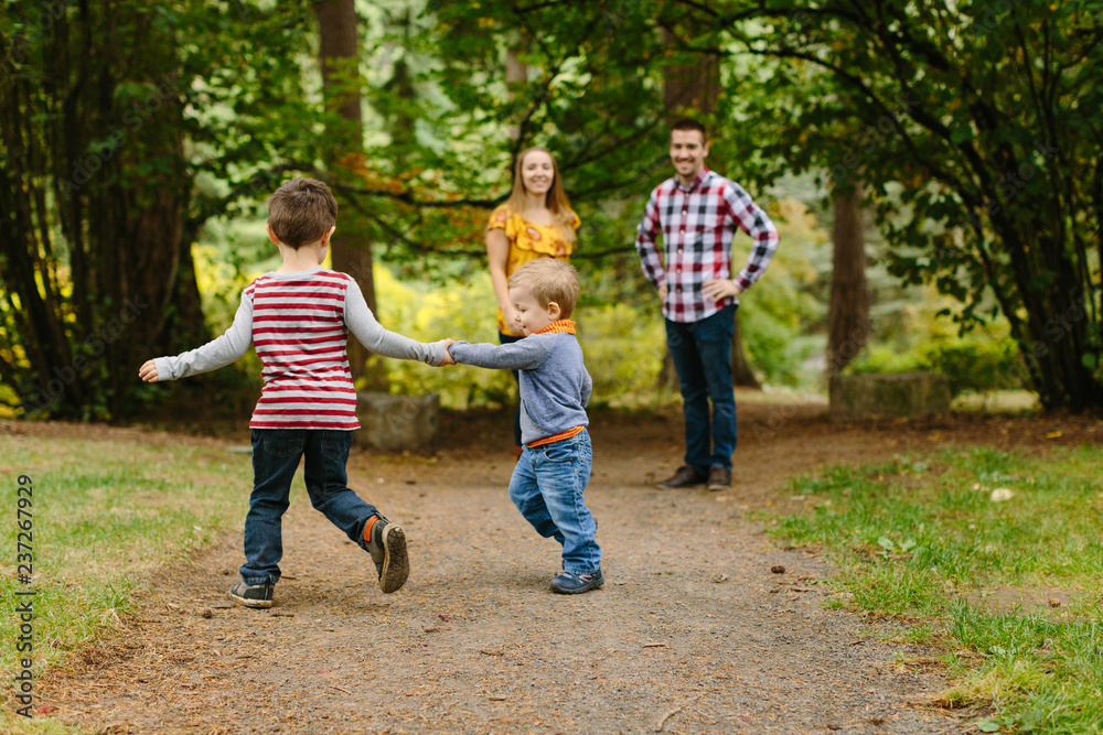 Kids Running in Park with Parents Watching Kids Running in Park with Parents Watching
