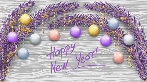 Merry Christmas and Happy New Year 2019. Purple branches of a Christmas tree in the snow. New Year's holiday decorations, garlands, balls and golden ribbons. Light woody background. 