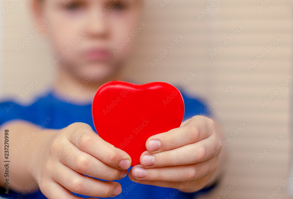 Red heart, stretches the boy forward with his hands Red heart, stretches the boy forward with his hands