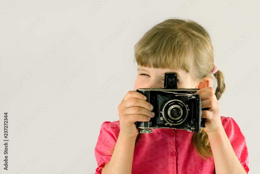 little girl takes pictures with an old camera little girl takes pictures with an old camera