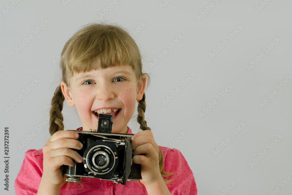 little girl with an old camera