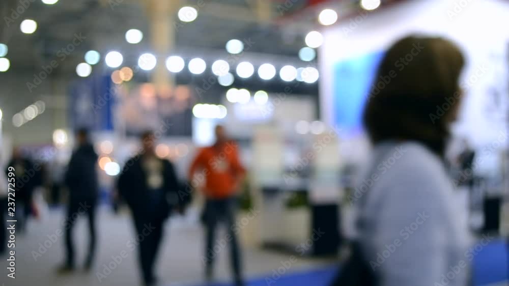 Abstract Defocused Blurred Background flow of many people inside space shopping center or mall, exhibition, exposition, hall real time.