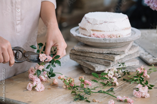 Person cutting flowers for cake photo