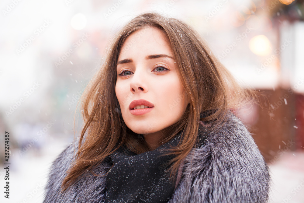 Young brunette woman in a gray coat with a fur collar Young brunette woman in a gray coat with a fur collar