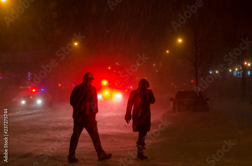 NEW YORK, USA – November 22,2018 : People crossing the street during a NYC snowstorm