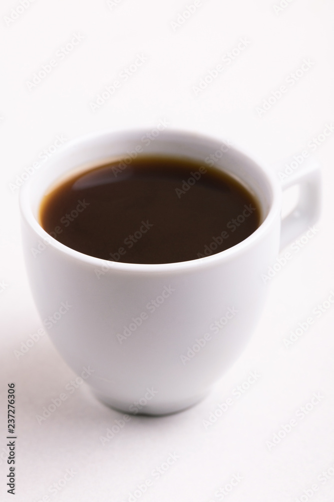 Cup of black strong coffee for breakfast on light background
