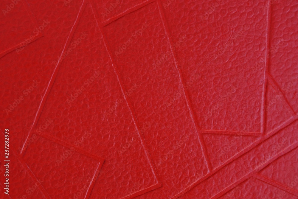 Fototapeta premium red paper texture of a piece of cardboard with a pattern