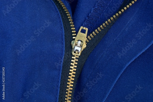 open yellow metal zip on blue clothes