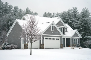 Winter house with woods in snow storm 