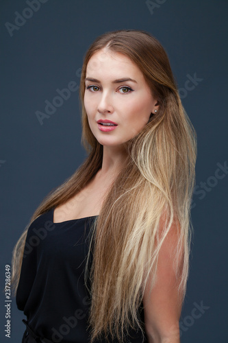 Beautiful blonde woman in black dress