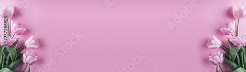 Pink tulips flowers on pink background. Waiting for spring. Happy Easter card. Flat lay, top view