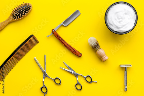 barbershop desk with tools for male care yellow background top view