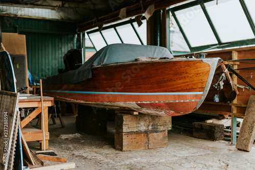 Принти на полотні Old wooden boat in a garage