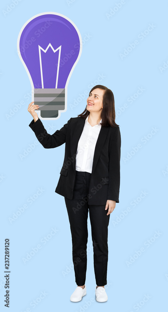 Businesswoman standing holding a purple light bulb Businesswoman standing holding a purple light bulb
