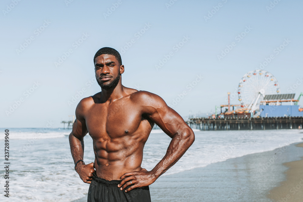 Fit man posing at the beach Stock Photo | Adobe Stock