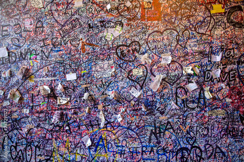 Graffiti on the brick vole Juliet's house in Verona. Wall covered with love messages, Juliet's House, Verona, Italy.