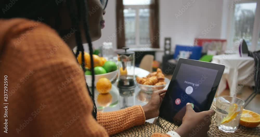 African american girl talking to her brother on video from student hostel