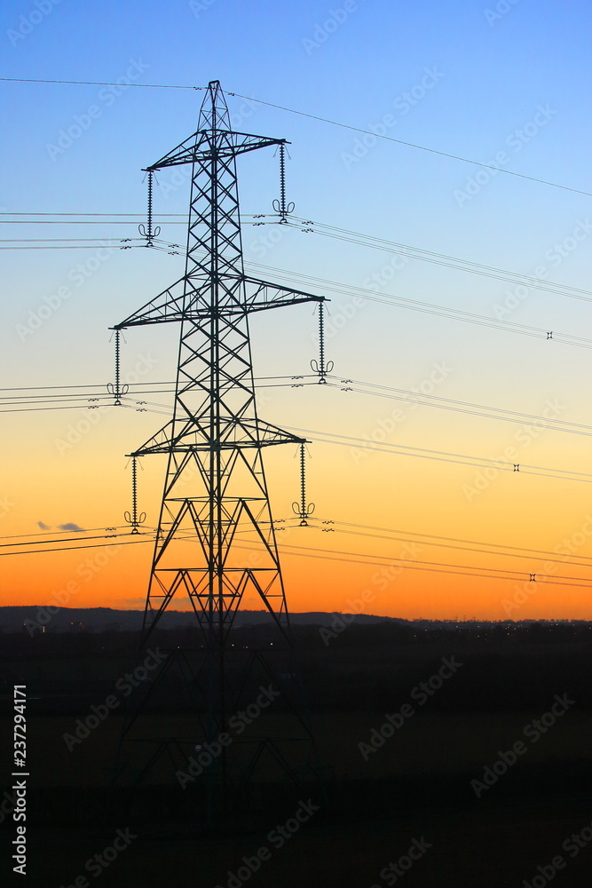 Electricity pylon tower with a colourful sunset, Bedfordshire, England, UK