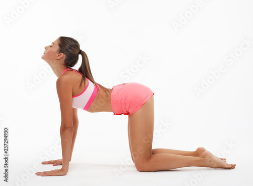 Young woman practicing yoga, working out, wearing sportswear, st